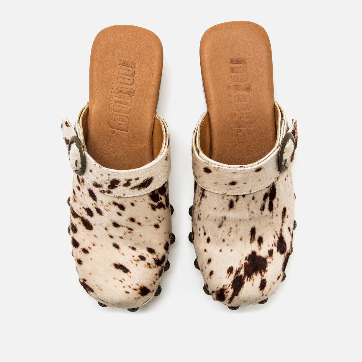 Look com tamancos Mustang Elois de padrão animal print e palmilha Comfort para conforto ao longo do dia.