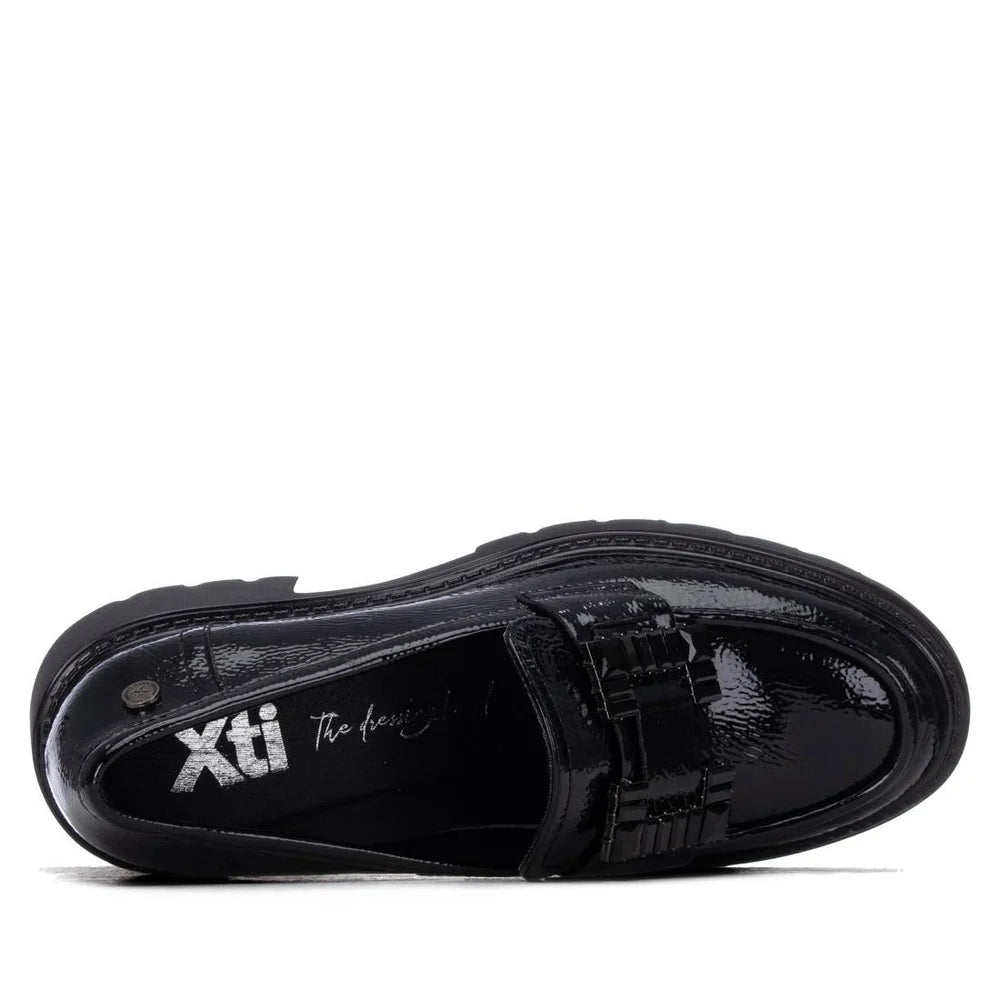 Sola do mocassim Xti preto vista de baixo, com o logótipo Xti gravado e o piso tratorado antiderrapante.